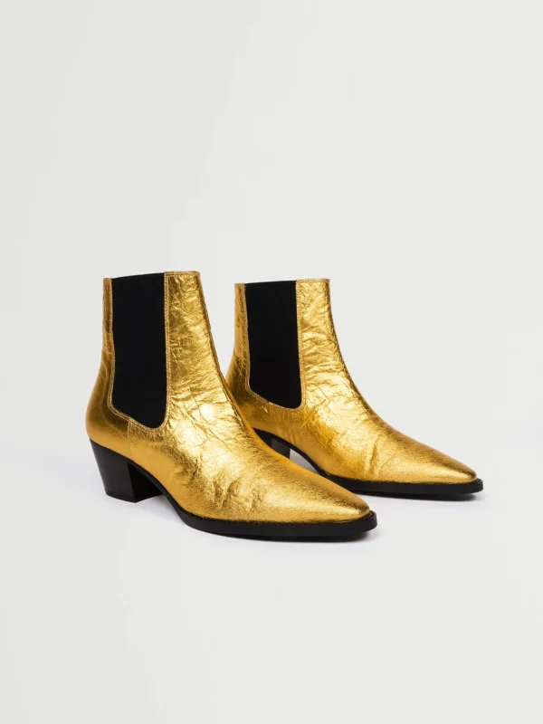 Goldene vegane Lederstiefel