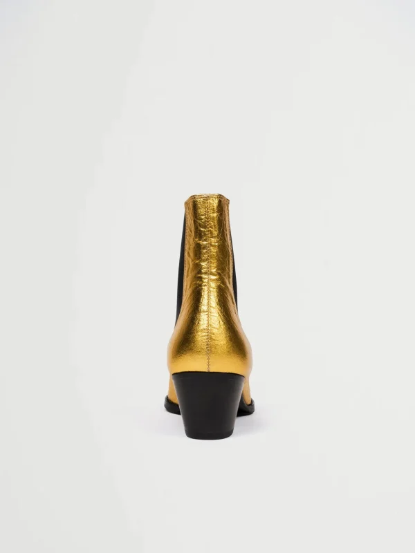 Goldene vegane Lederstiefel