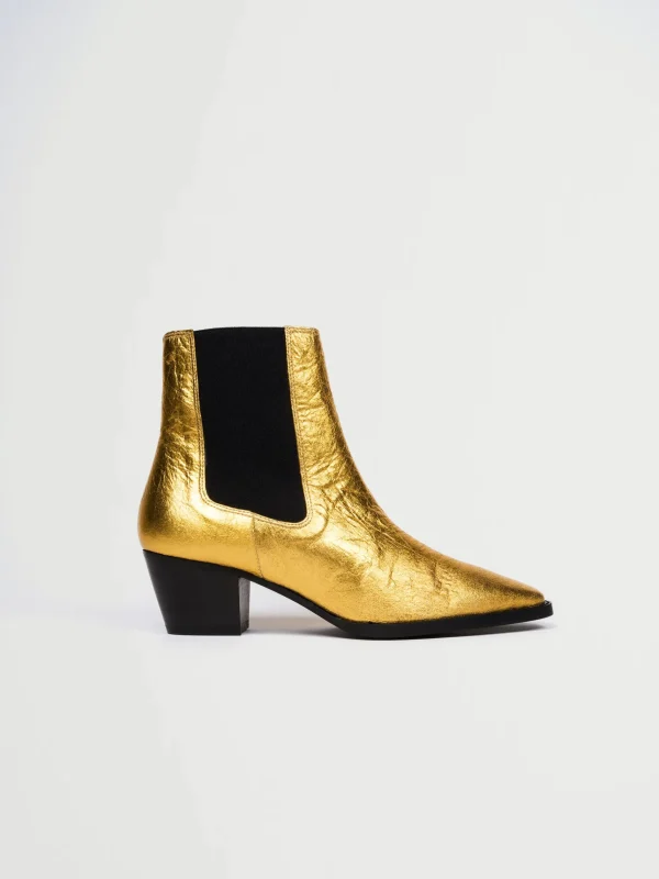 Goldene vegane Lederstiefel